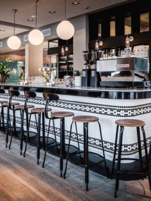 Chaise Nicolle H75-cm, wood and metal - A stylish and sturdy French chair with a height of 75-cm. Image description: A beautiful Chaise Nicolle Rotterdam barstool - a sleek and elegant addition to any bar or kitchen counter.