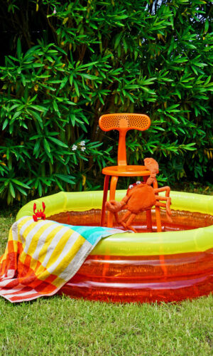 Outdoor orange nicolle chair in a swimming pool