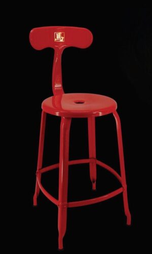 Red stool with a modern design on a black background.