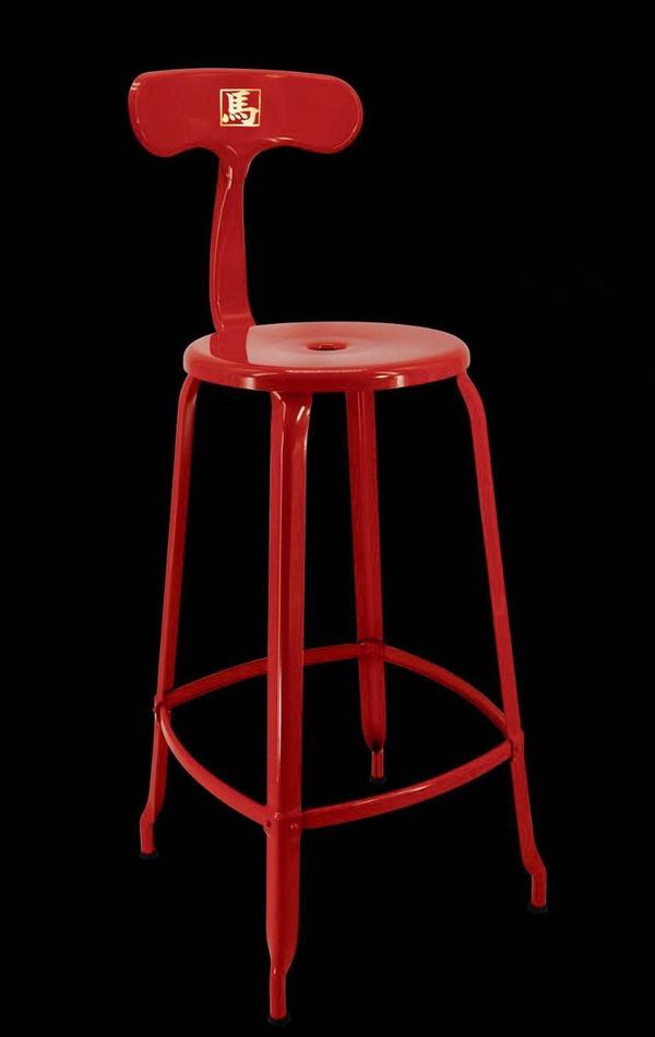 Red metal stool on a black background.